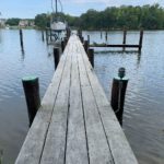 An aged wooden walkway leading to a dock